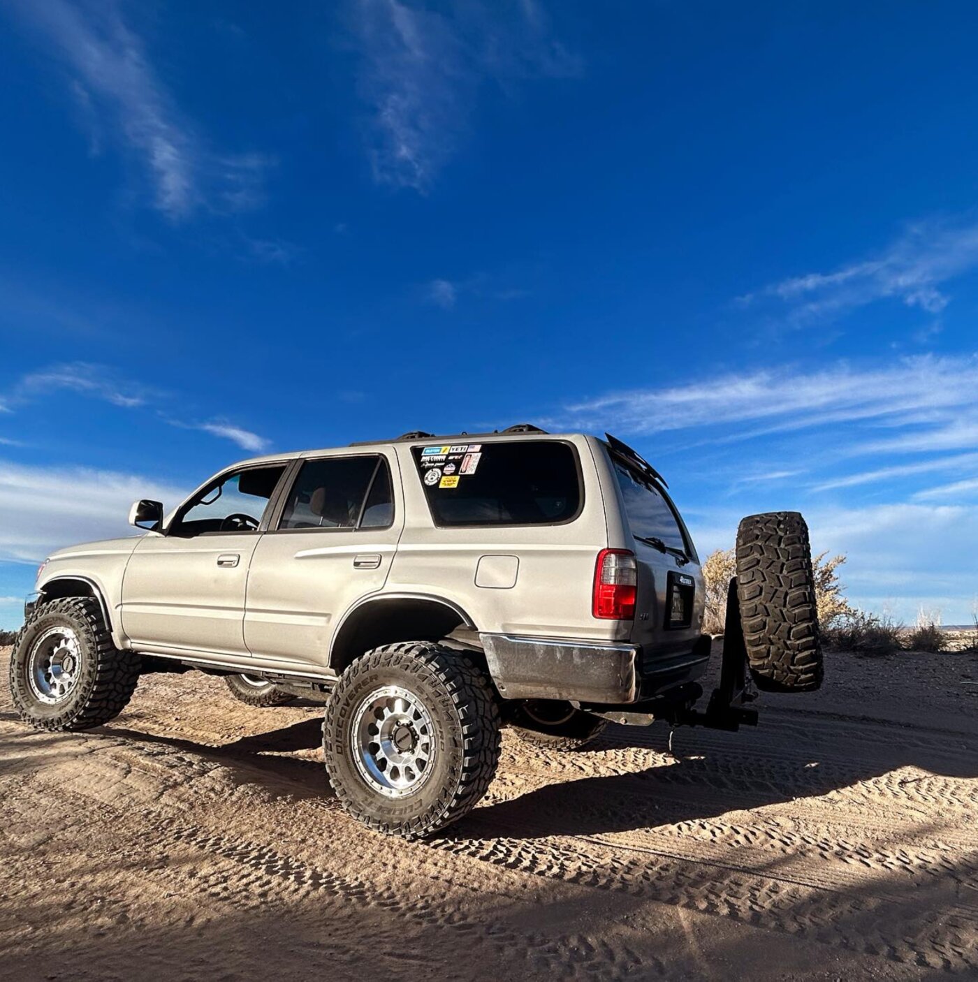 A lifted Toyota 4Runner with off-road tires parked in the New Mexico desert