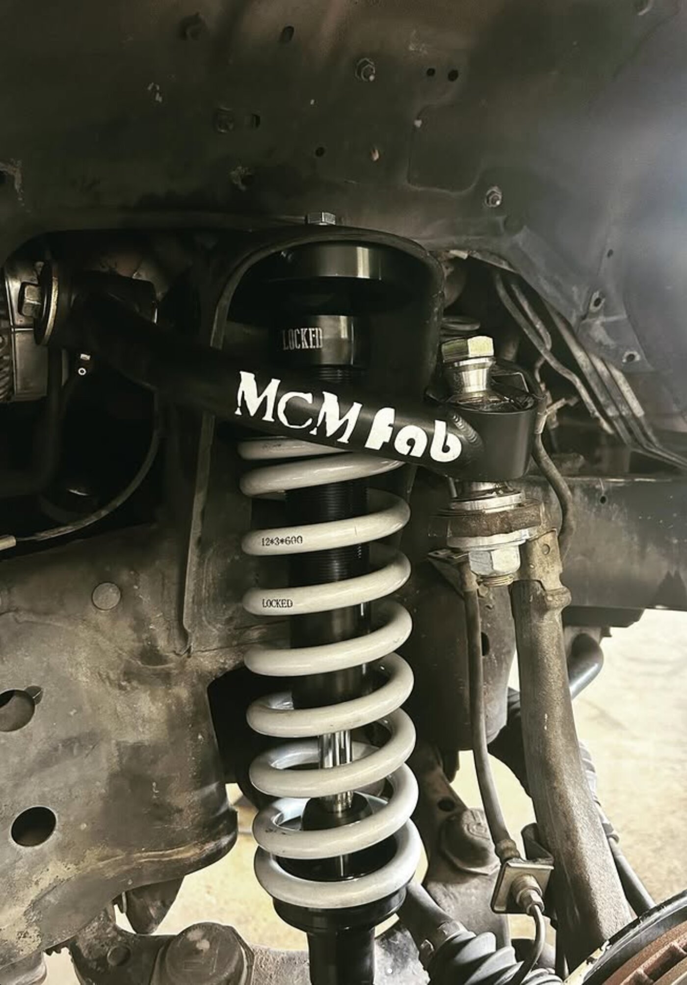 Close-up of a freshly installed coilover suspension kit